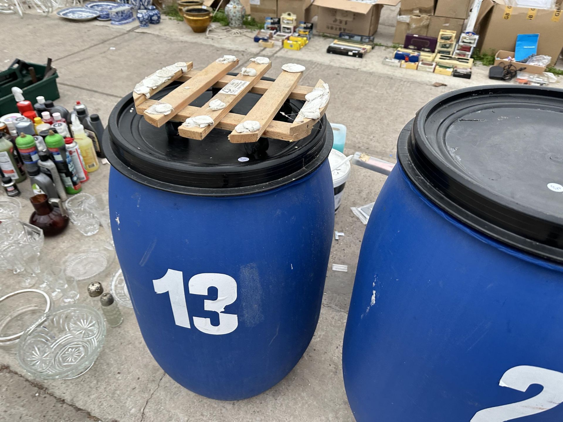 THREE LIDDED PLASTIC DRUMS TWO WITH TROLLEY BASES - Image 2 of 2