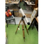 A STUDENTS TELESCOPE ON WOODEN TRIPOD BASE