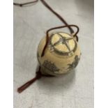 A BONE CARVED COMPASS ON A CORD