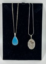TWO .925 SILVER NECKLACES WITH BLUE STONE AND LOCKET PENDANT DESIGNS, LARGEST 20" CHAIN LENGTH