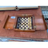 A VINTAGE MAHOGANY FOLDING TRAVEL CHESS SET WITH BRASS HINGES AND CLASPS