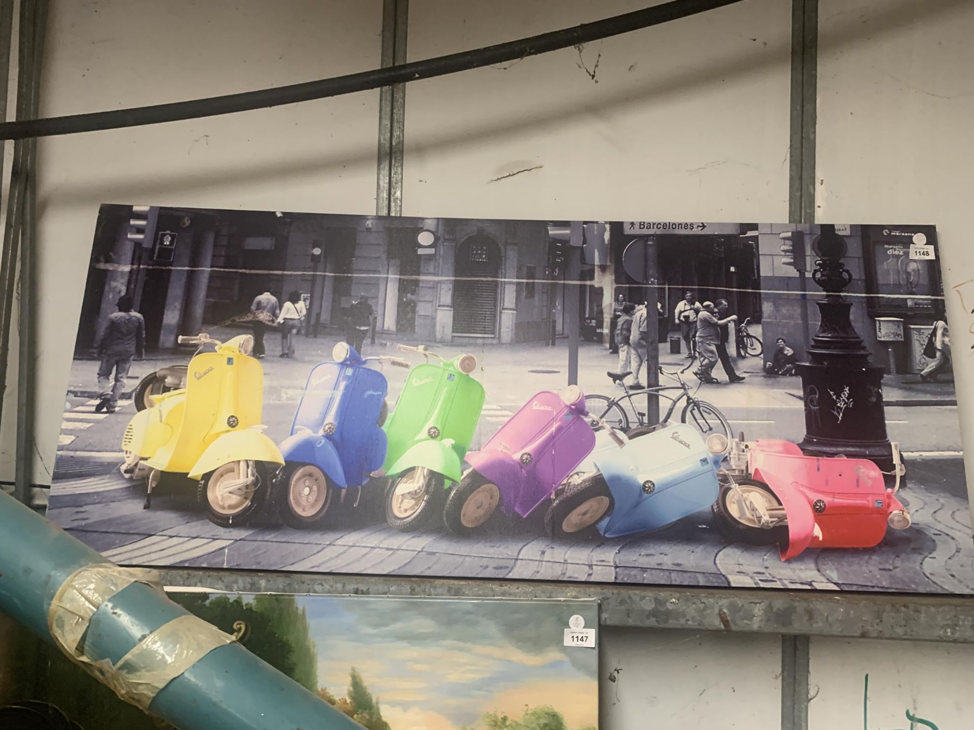 A LARGE CANVAS BOX POSTER OF SIX VESPA SCOOTERS, 48" X 20"