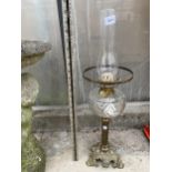 A VINTAGE BRASS OIL LAMP WITH GLASS FUNNEL