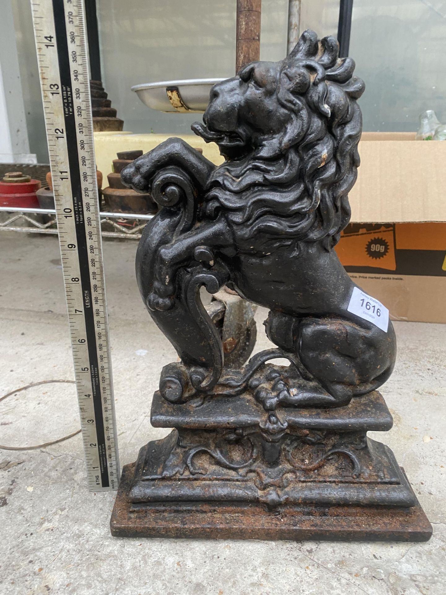 A VINTAGE CAST IRON LION DESIGN DOOR STOP