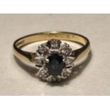 AN 18 CARAT GOLD RING WITH CENTRE SAPPHIRE SURROUNDED BY EIGHT DIAMONDS SIZE L