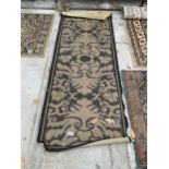 A BLACK AND BEIGE PATTERNED RUG