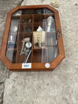 A VINTAGE GLASS FRONTED DISPLAY CABINET WITH AN ASSORTMENT OF ITEMS TO INCLUDE A PIPE AND