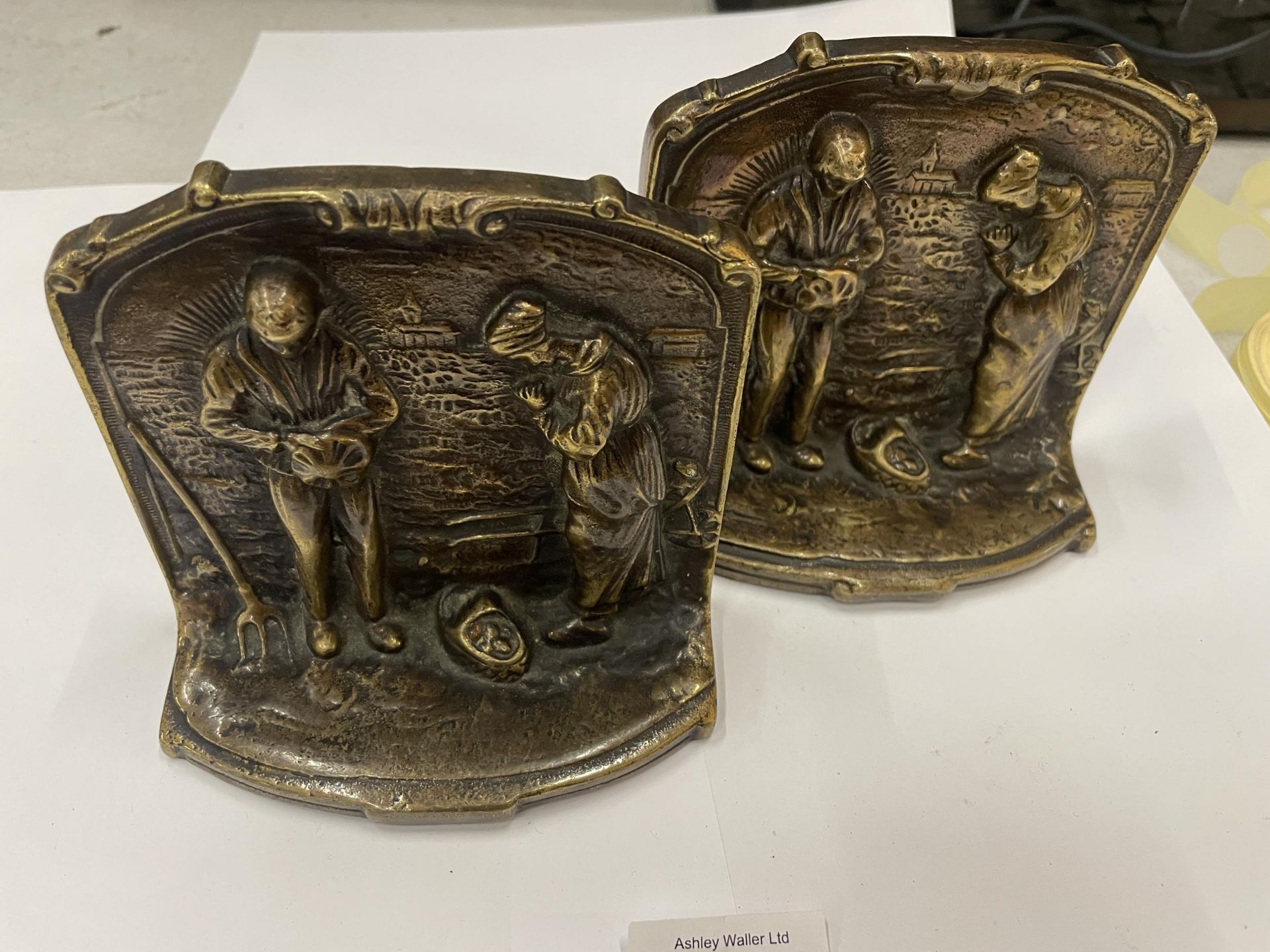 A PAIR OF VINTAGE BRONZE BOOK ENDS WITH RELIGIOUS DESIGN