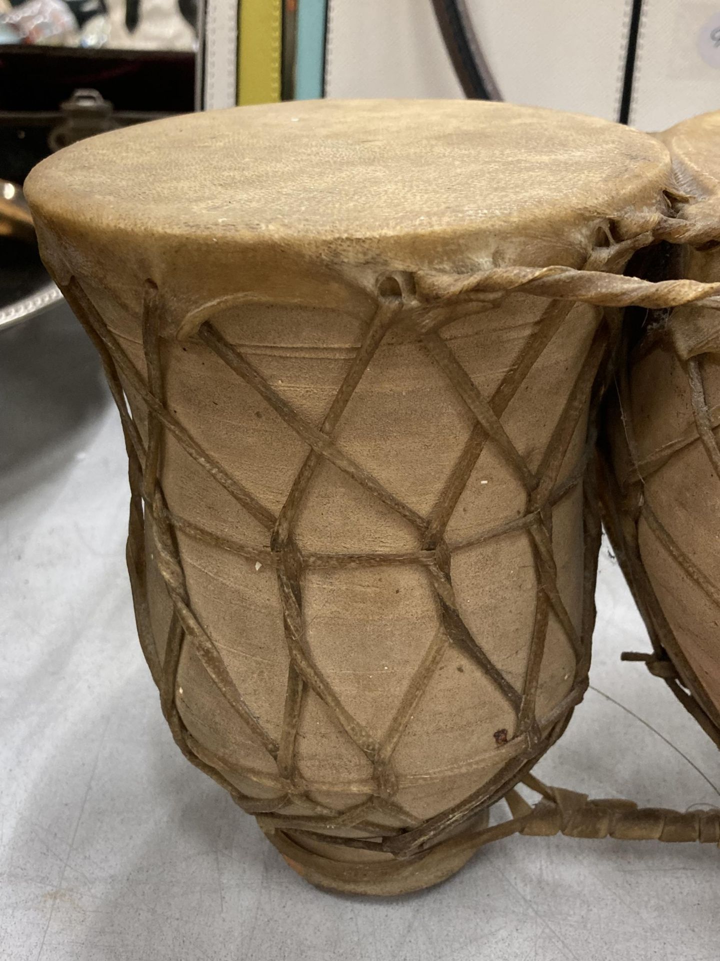 A SET OF TWO ANIMAL HIDE AFRICAN DRUMS - Image 2 of 4