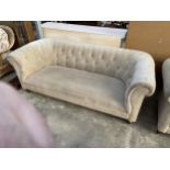 A MODERN THREE SEATER CHESTERFIELD SETTEE