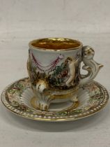 AN ITALIAN CAPODIMONTE CLASSICAL GILT DESIGN CUP AND SAUCER