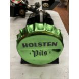 A NEW HOLSTEN PILS BOTTLE OPENER AND BOTTLE TOP HOLDER