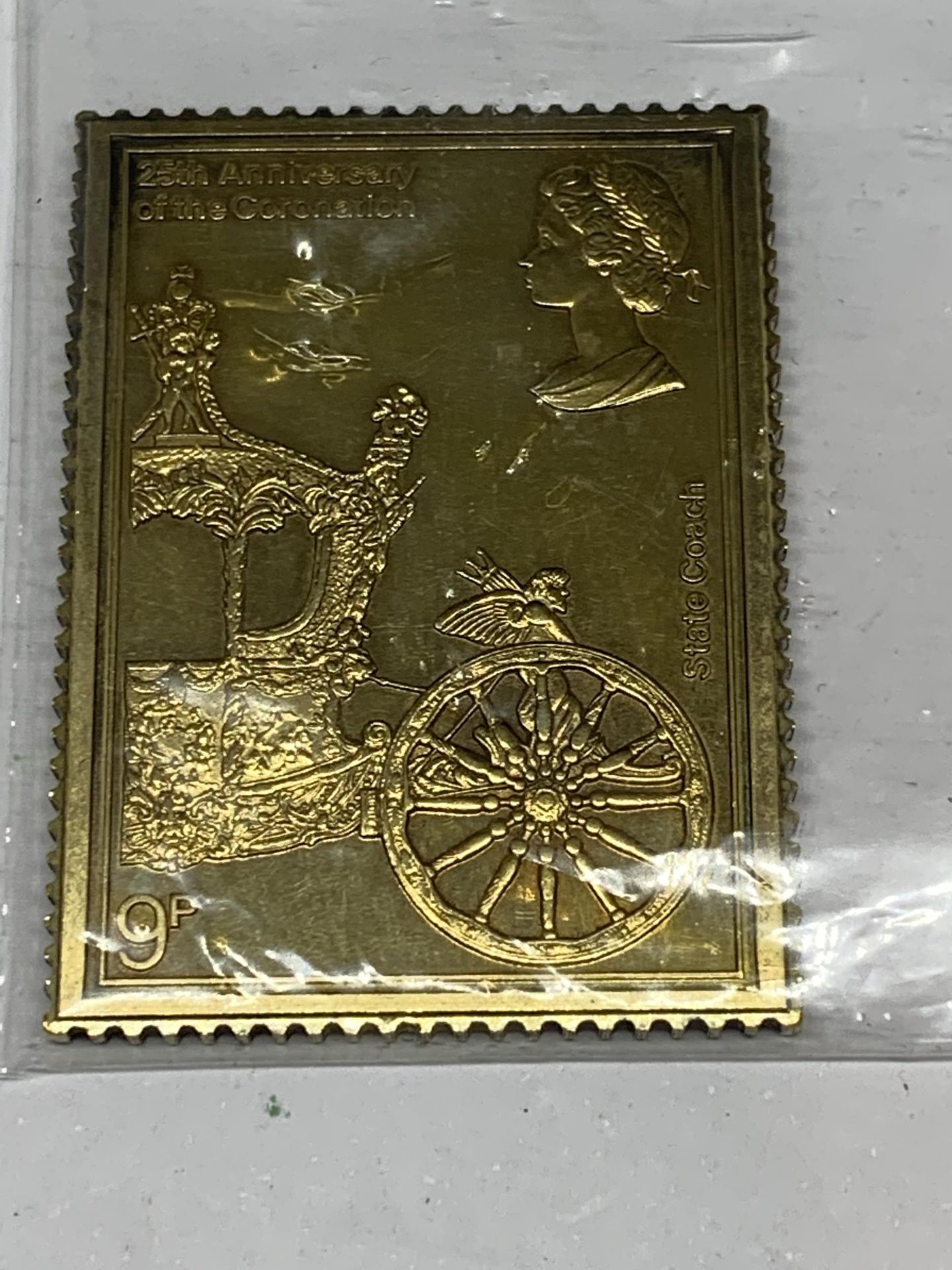 A SILVER GILT 9P STAMP INGOT