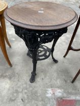 A CAST IRON PUB TABLE DECORATED WITH RAMS HEADS, COMPLETE WITH 23" DIAMETER TOP