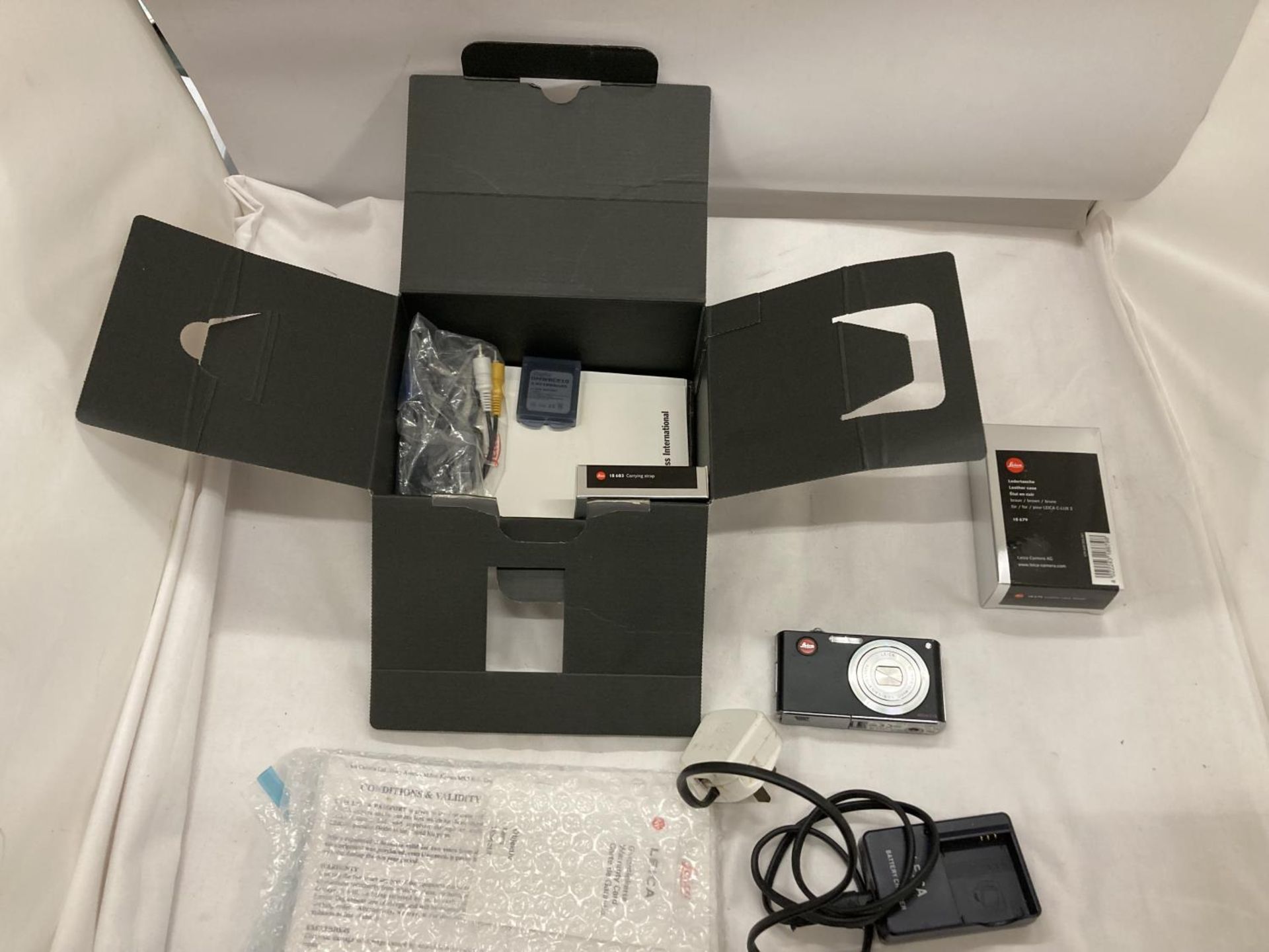 A LEICA CAMERA IN ORIGINAL BOX TOGETHER WITH PAPERWORK AND BATTERY CHARGER AND INSTRUCTIONS