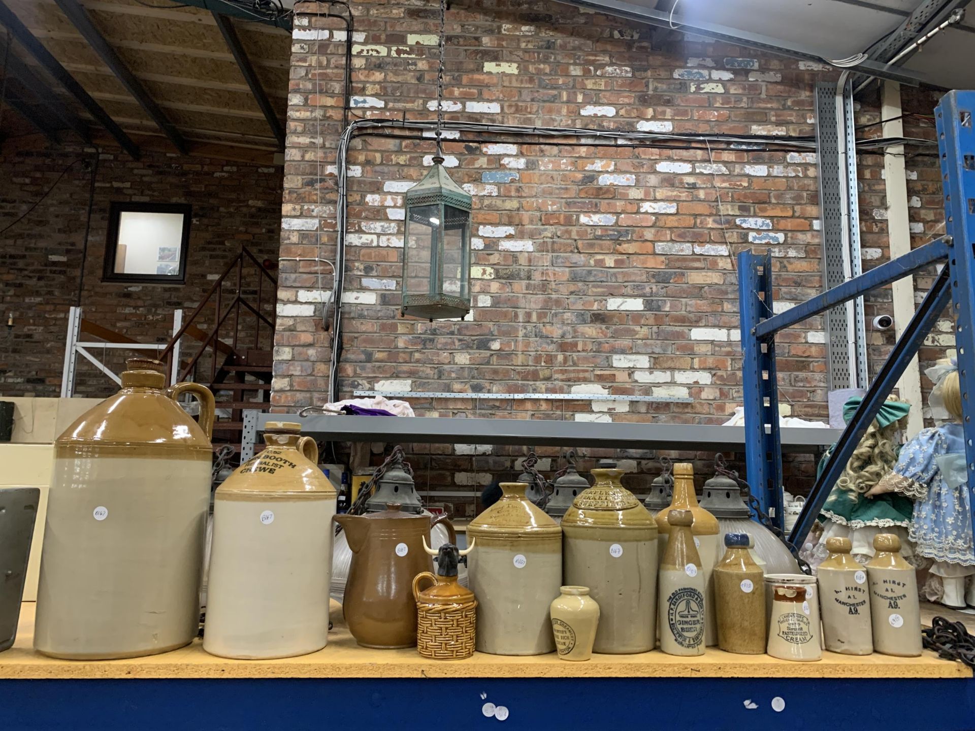 A COLLECTION OF VINTAGE STONEWARE BOTTLES / FLAGONS, INCLUDING LOCAL INTEREST MANCHESTER AND CREWE