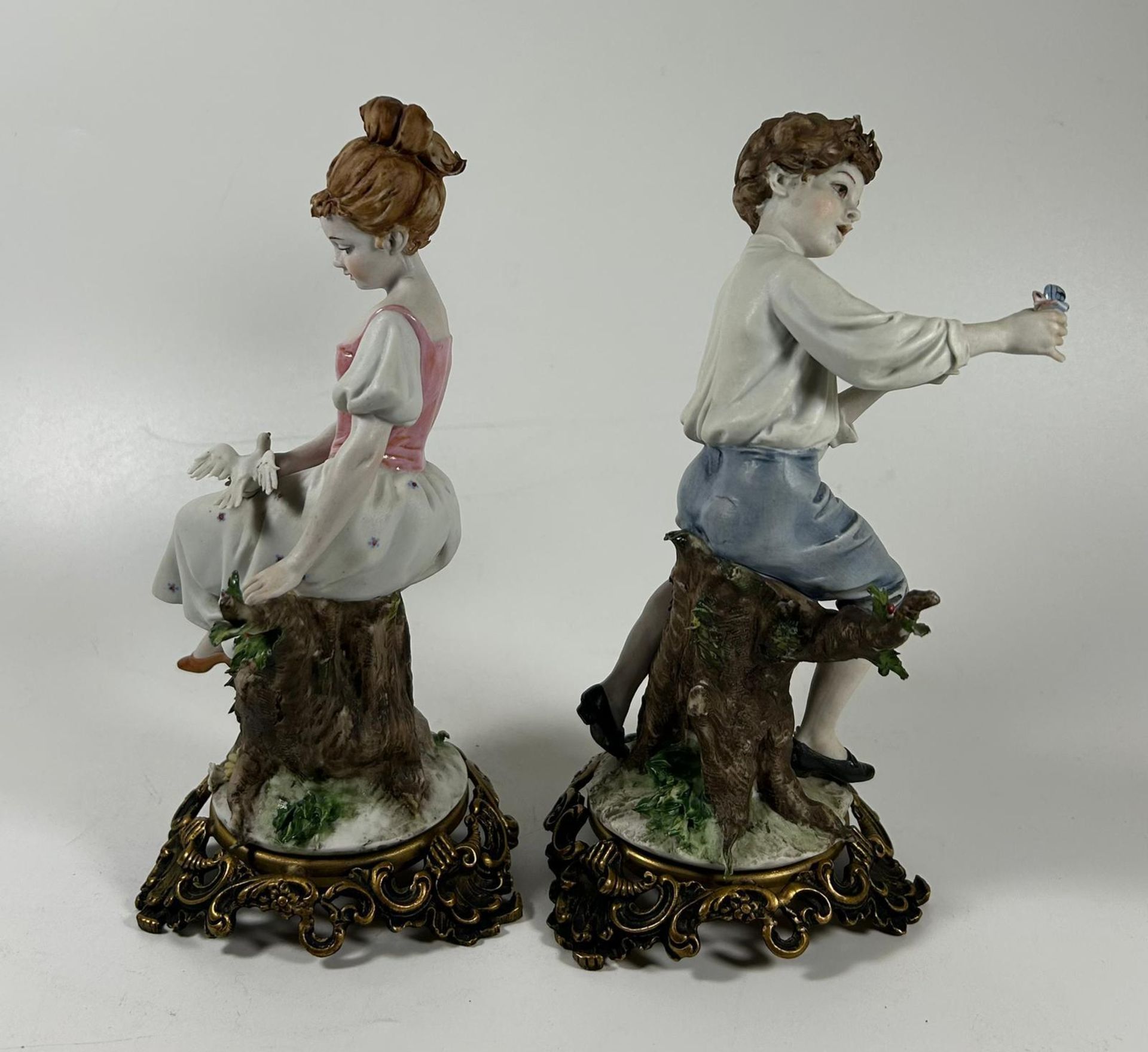 A PAIR OF CONTINENTAL PORCELAIN FIGURES OF A BOY AND GIRL ON GILT METAL BASES - Image 3 of 4