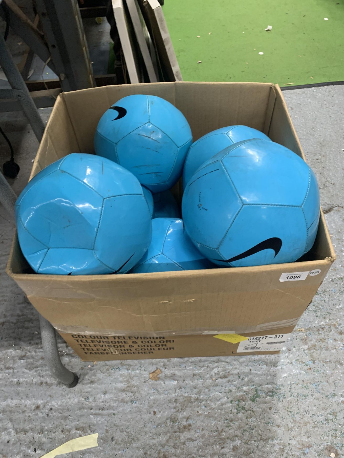 A BOX OF NIKE FOOTBALLS