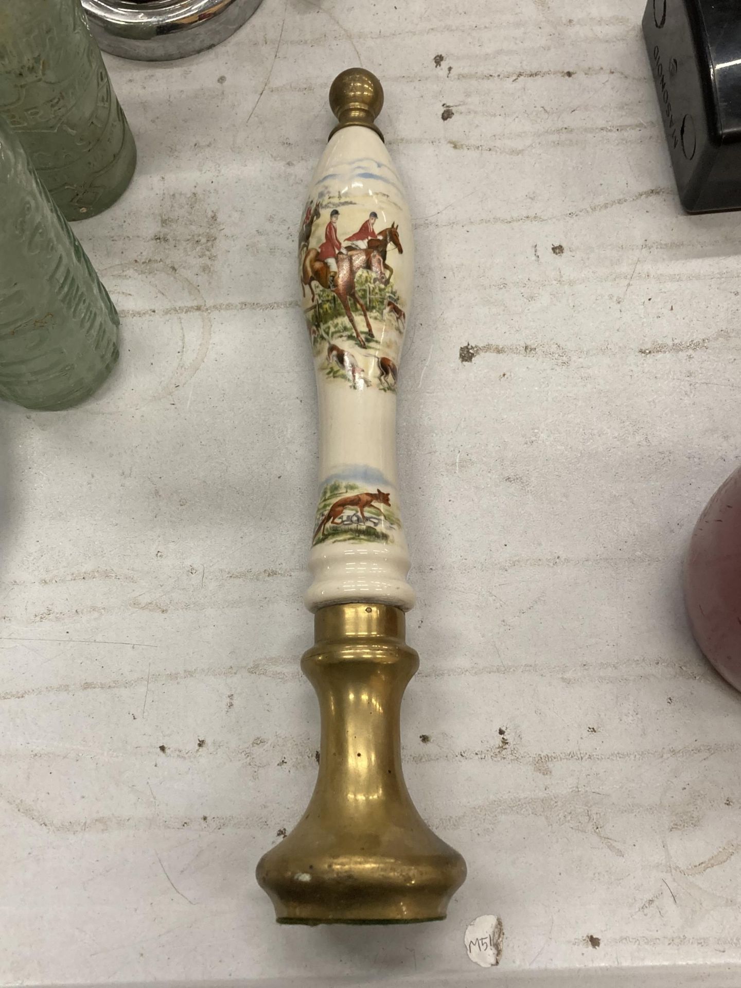 A VERY HEAVY SOLID BRASS AND CERAMIC HUNTSMAN PUMP