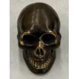 A SMALL BRONZE SKULL MODEL