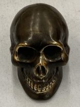 A SMALL BRONZE SKULL MODEL