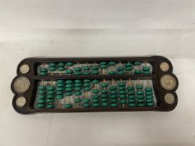 A CHINESE ABACUS WITH MALACHITE COUNTERS AND SILVER COINS