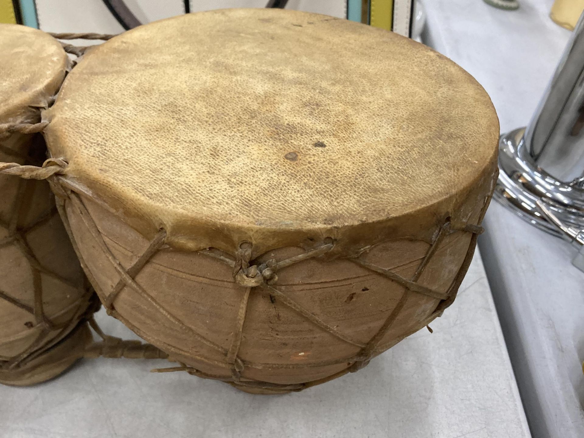 A SET OF TWO ANIMAL HIDE AFRICAN DRUMS - Image 3 of 4