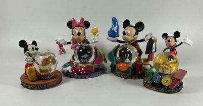 A GROUP OF FOUR DISNEY COLLECTABLE SNOWGLOBES, PLANE CRAZY, 2007 ETC