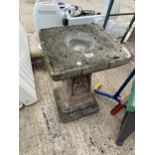 A CONCRETE GARDEN BIRDBATH WITH PEDESTAL BASE