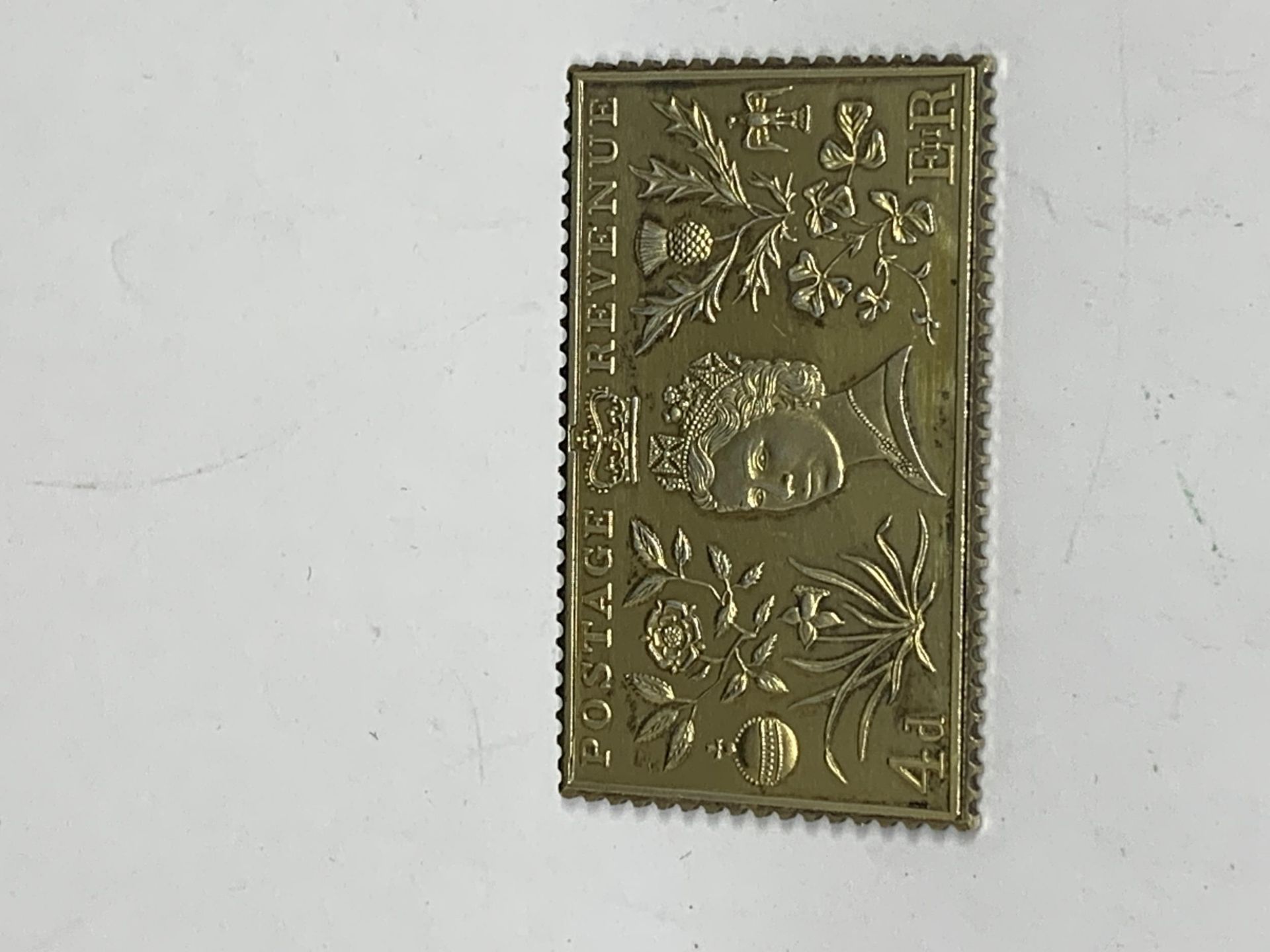 A SILVER GILT 4P STAMP INGOT