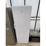 A TALL WHITE INDESIT UPRIGHT FRIDGE