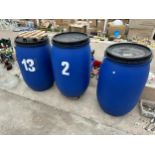 THREE LIDDED PLASTIC DRUMS TWO WITH TROLLEY BASES