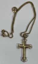 A TESTED 9CT YELLOW CRUCIFIX ON TESTED 9CT YELLOW GOLD CHAIN, GROSS WEIGHT 7.27 GRAMS