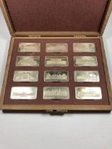 A CASED COLLECTION OF 12 SOLID SILVER INGOTS OF ROYAL PALACES BY THE BIRMINGHAM MINT A LIMITED