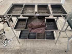 AN ALUMINIUM POTTING TABLE WITH PLASTIC TRAYS