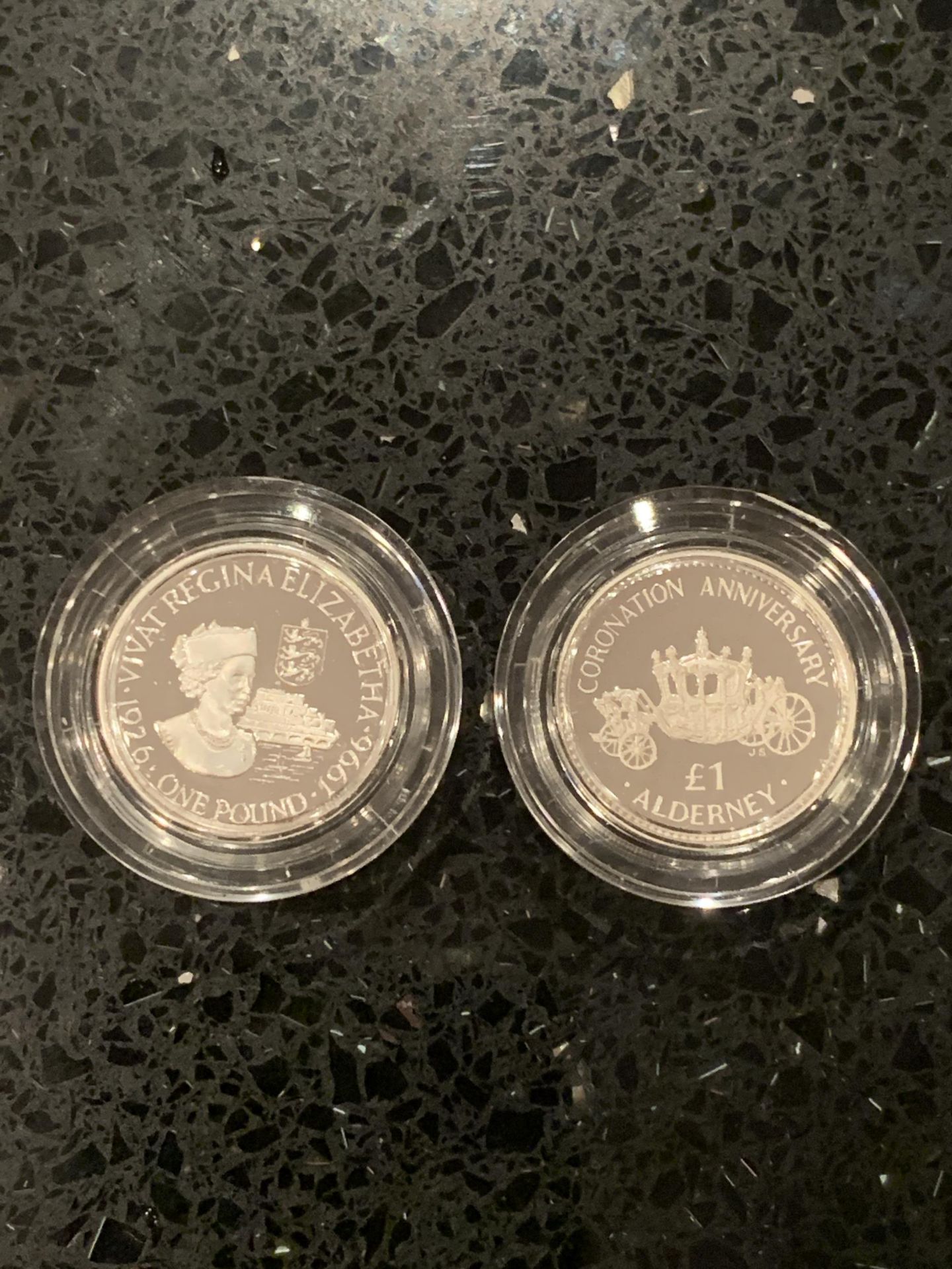 UK TWO SILVER PROOF £1 COINS , BOTH ENCAPSULATED . ONE IS ALDERNEY 1993 , THE OTHER GUERNSEY 1996
