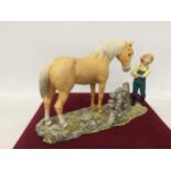 A HEREDITIES FIGURE OF A GIRL WITH PONY, NO. PG21 WITH BOX, DATED AND SIGNED 1987