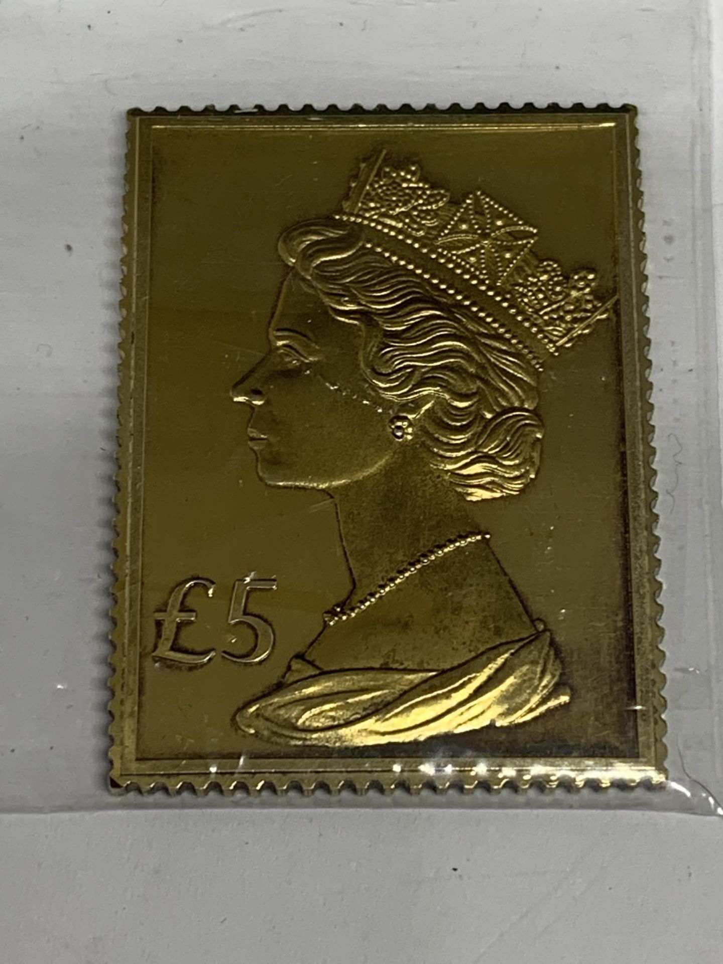 A SILVER GILT £5 STAMP INGOT