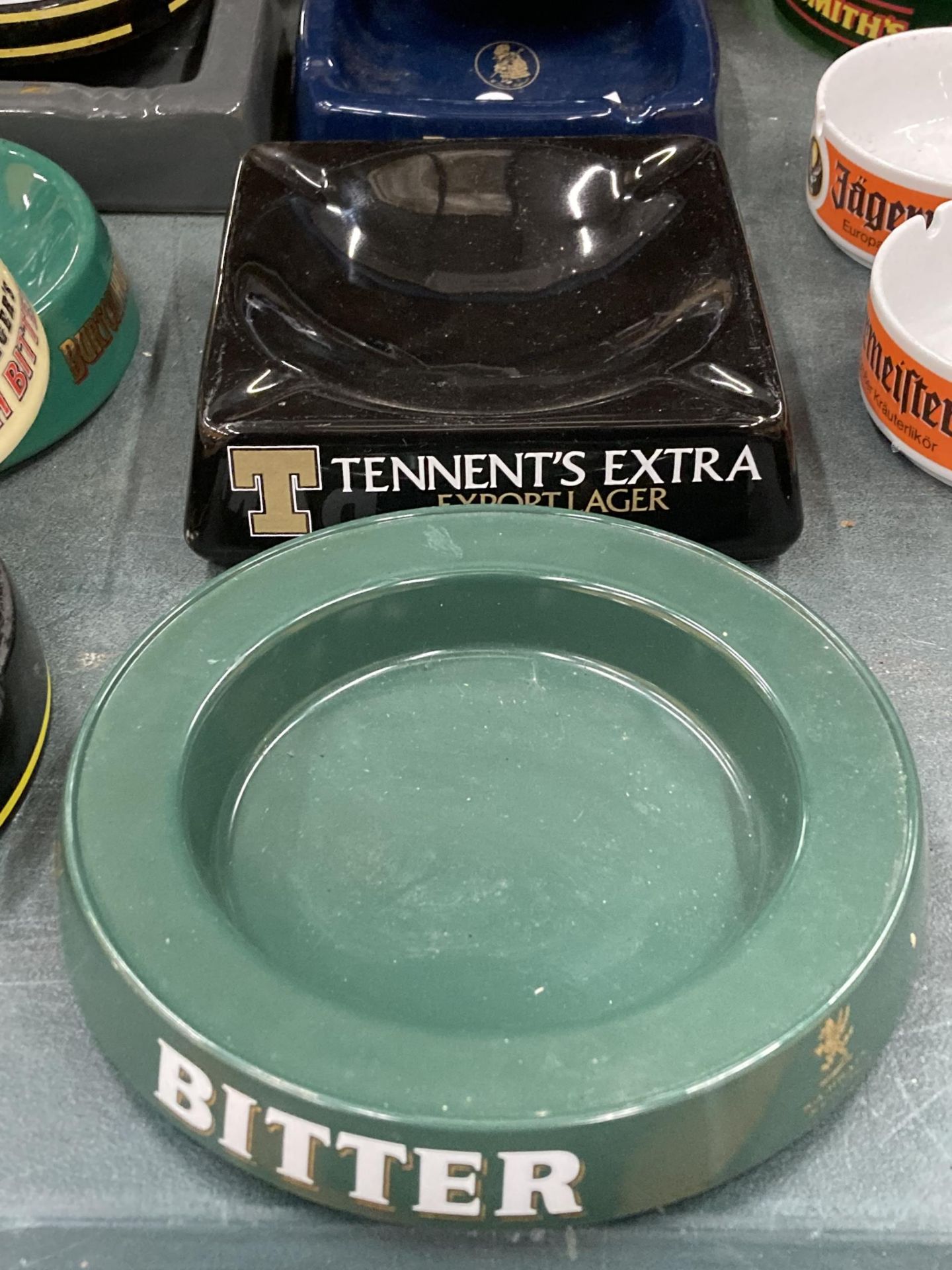 A TENNENT'S CERAMIC AND A S. A. BRAINS MELAMIME ASHTRAYS