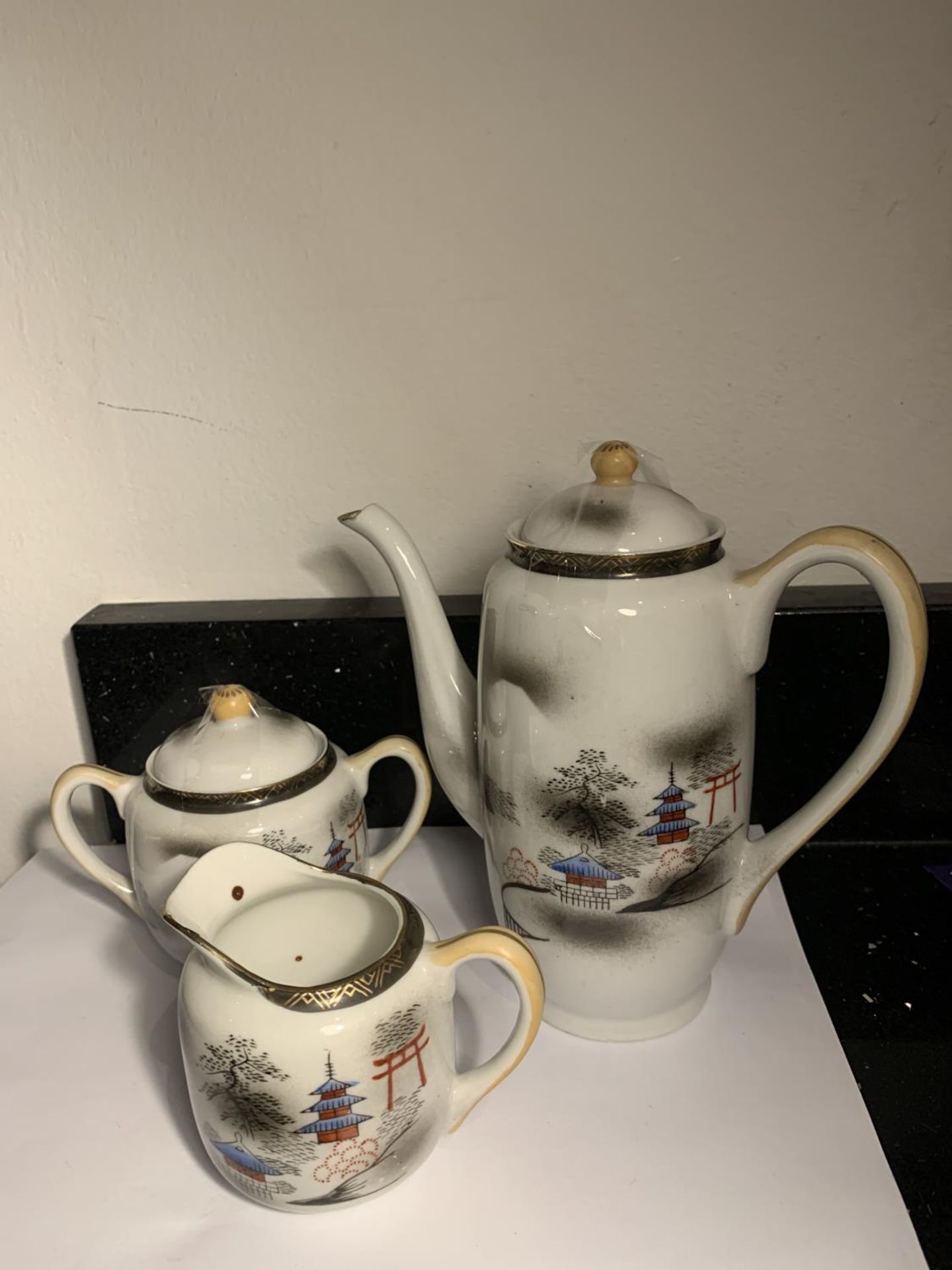 AN ORIENTAL COFFEE POT WITH JUG AND LIDDED SUGAR BOWL