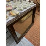 A VINTAGE LARGE HEAVY WALL MIRROR IN A WOOD AND GILT FRAME, 100CM X 75CM - FRAME IN NEED OF