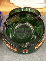 TWO JOHN SMITH'S GLASS ASHTRAYS