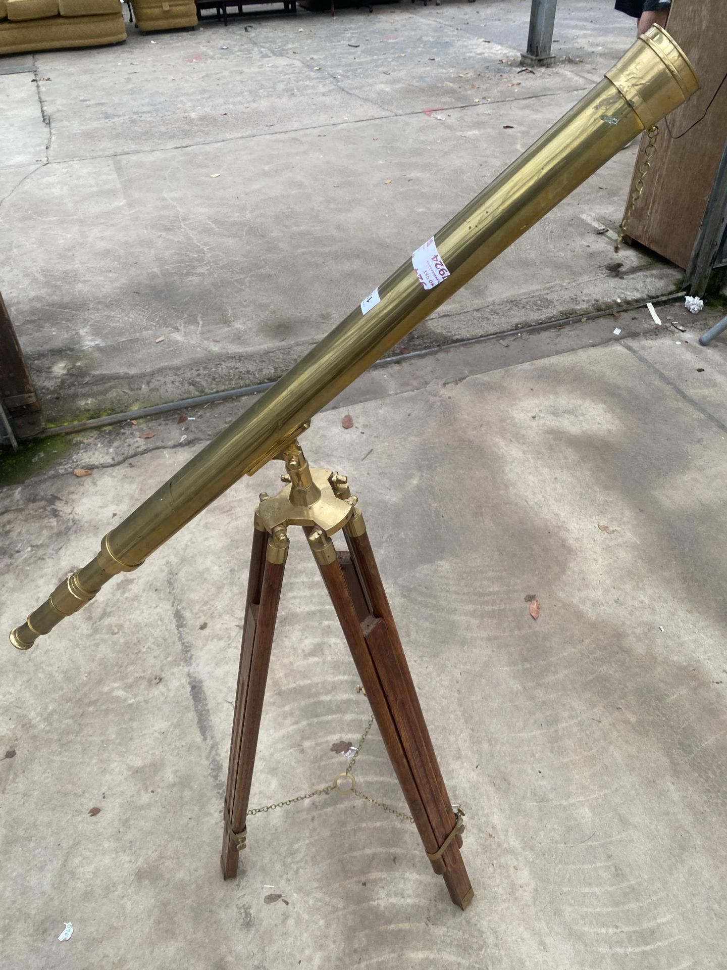 A VINTAGE BRASS TELESCOPE WITH WOODEN TRIPOD STAND
