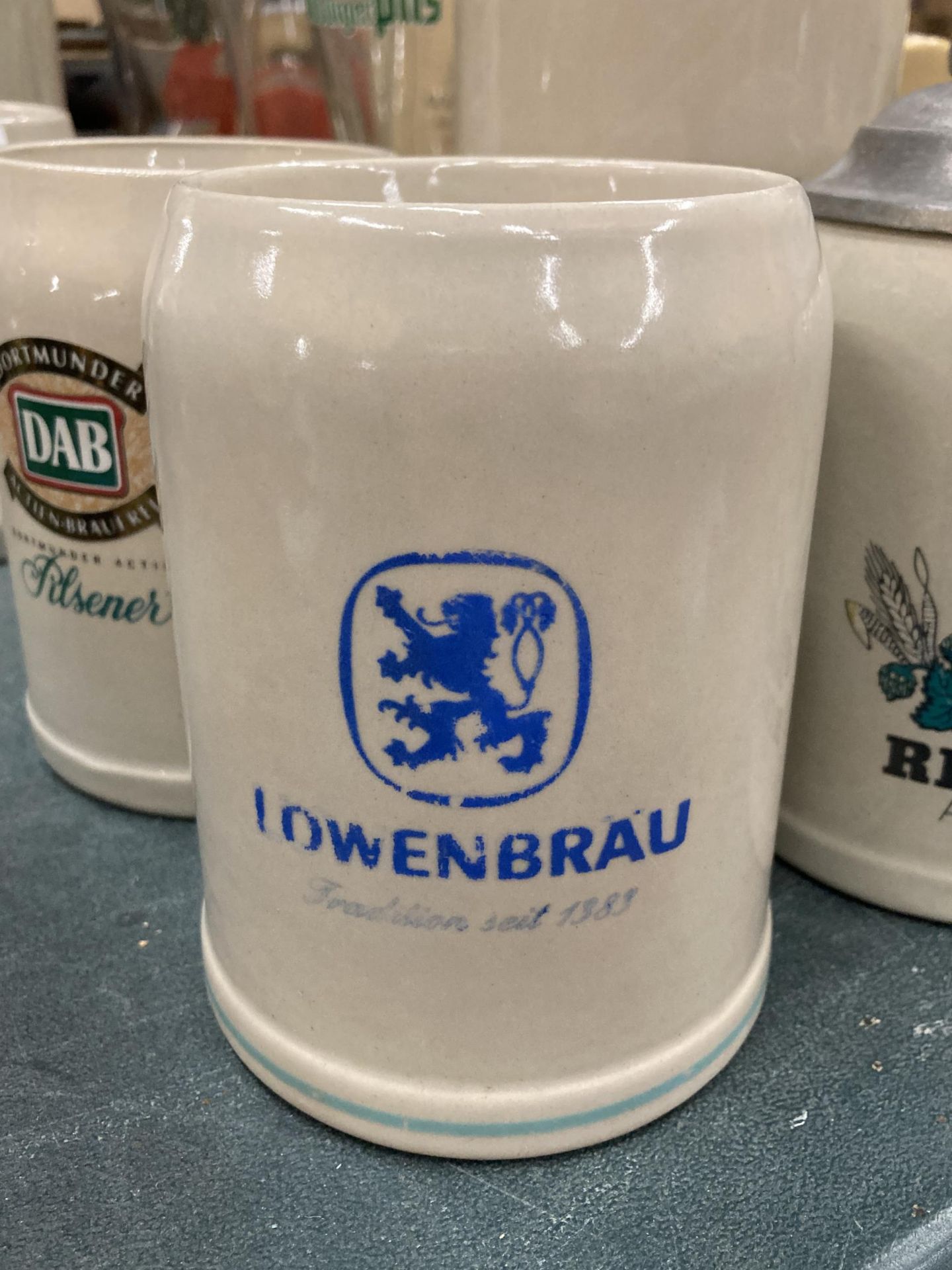 FOUR STONEWARE STEINS TO INCLUDE KUNHLE, DAB, RIEGELE AND LOWENBRAU - Image 3 of 5
