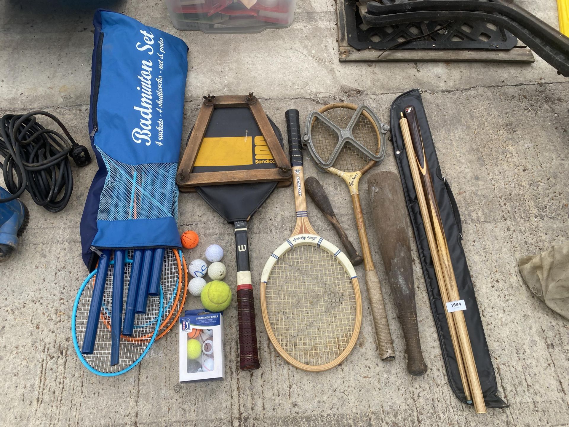 AN ASSORTMENT OF SPORTS EQUIPMENT TO INCLUDE A CRUCIBLE CC LTD SNOOKER CUE, TENNIS RACKETS WITH