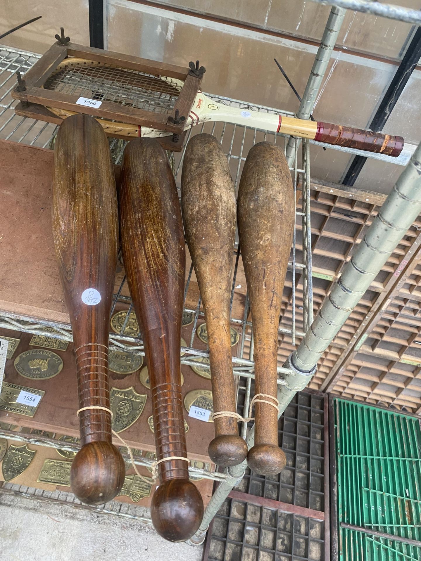 A VINTAGE WOODEN TENNIS RACKET WITH WOODEN COVER AND TWO PAIRS OF WOODEN JUGGLING CLUBS