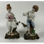 A PAIR OF CONTINENTAL PORCELAIN FIGURES OF A BOY AND GIRL ON GILT METAL BASES