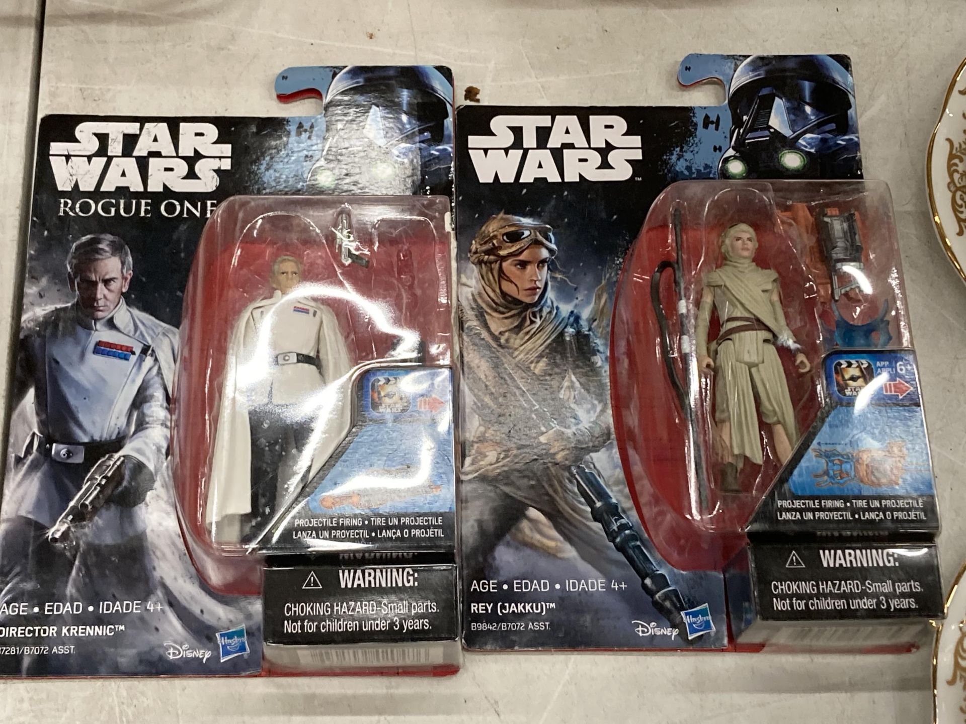 TWO STAR WARS FIGURES, REY AND DIRECTOR KRENNIC, MINT ON CARDS