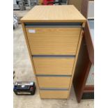 A FOUR DRAWER WOODEN FILING CABINET
