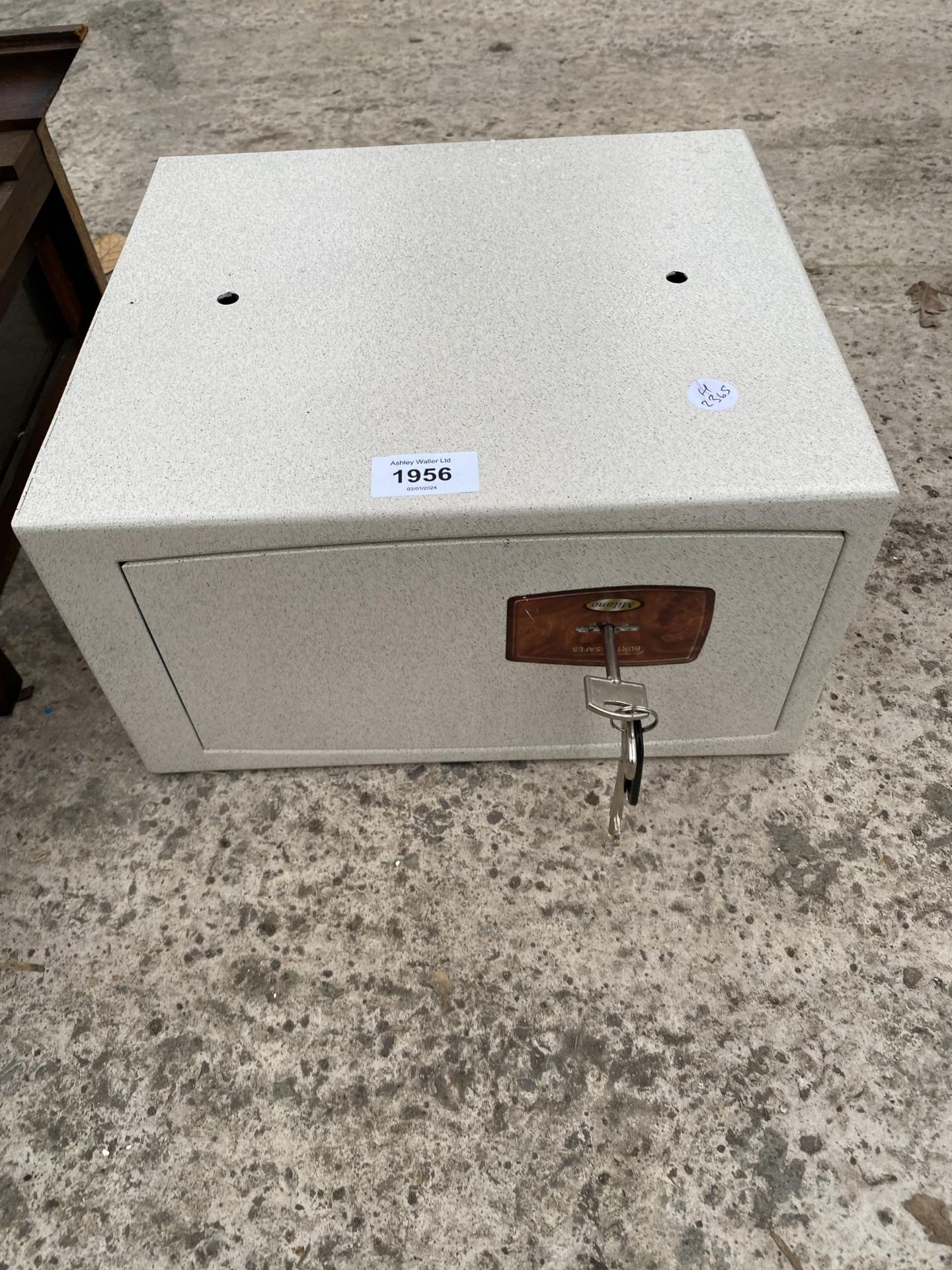 A SMALL METAL SAFE COMPLETE WITH KEY